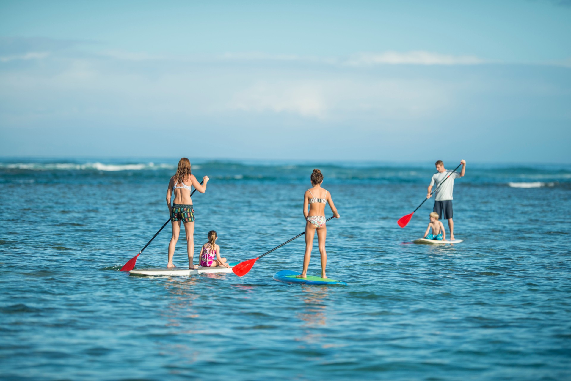 Family paddleboarding in Hawaii