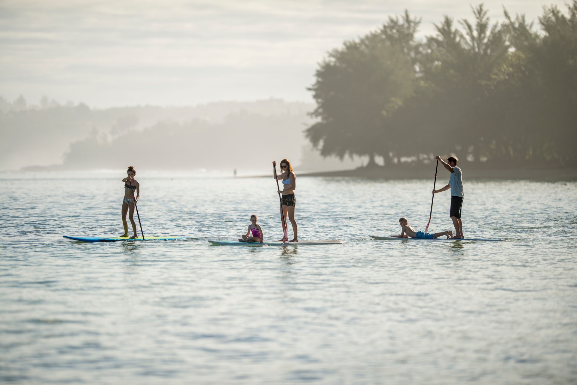 Family paddleboarding in Hawaii